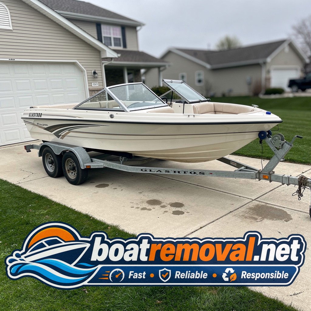 20-foot Glastron bowrider parked on a trailer in an Ankeny, Iowa driveway