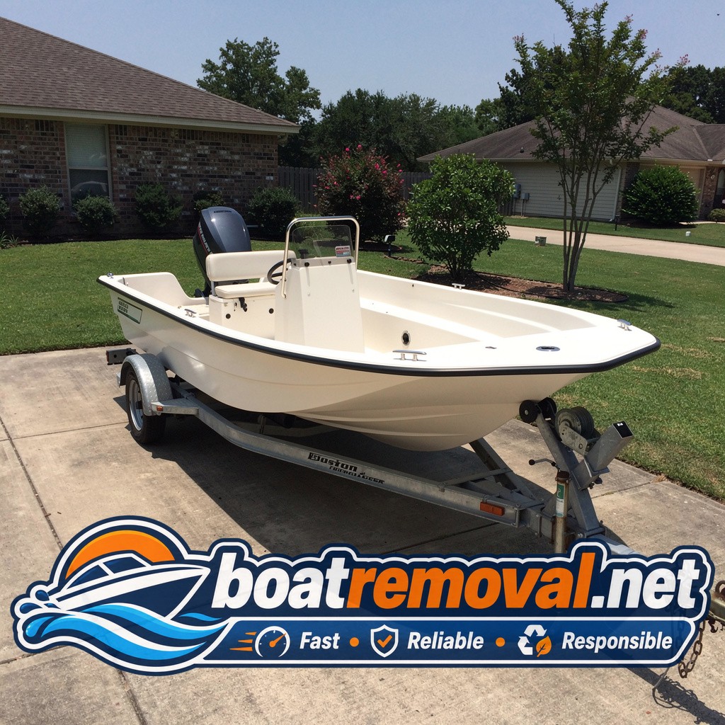 17-foot Boston Whaler skiff sitting on a trailer in a Baton Rouge, Louisiana driveway