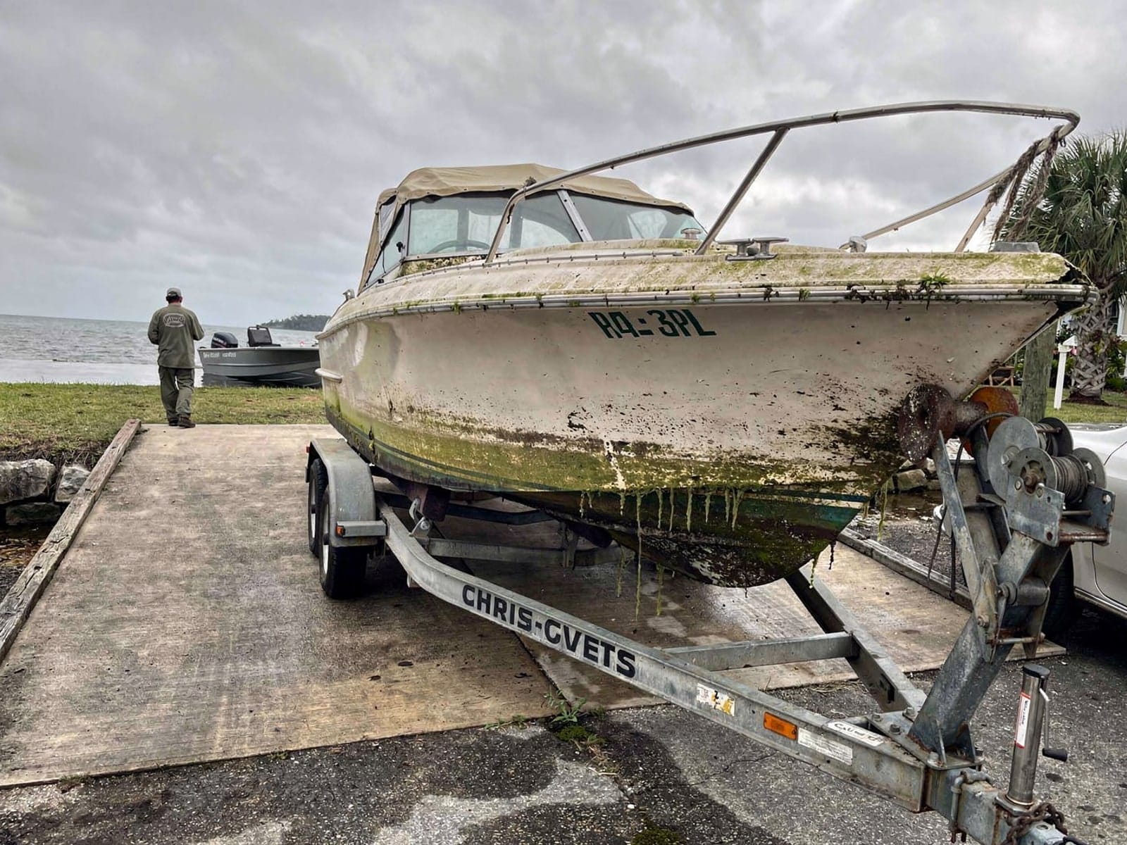 23 ft Chris-Craft Cavalier pulled out on a trailer at a Bee Ridge, FL boat ramp