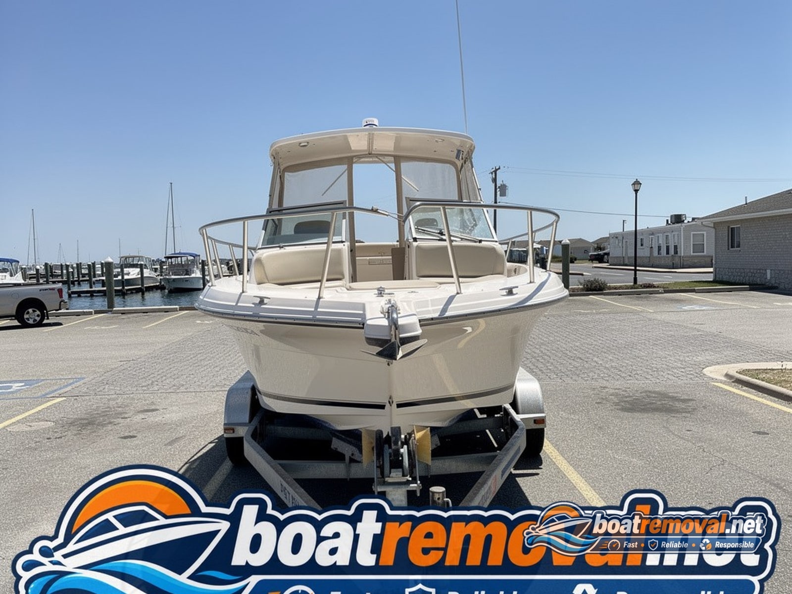 Bethany Beach, DE: 27-foot Regal cuddy cabin loaded for removal Regal cuddy cabin loaded onto a trailer after removal from a marina in Bethany Beach, Delaware
