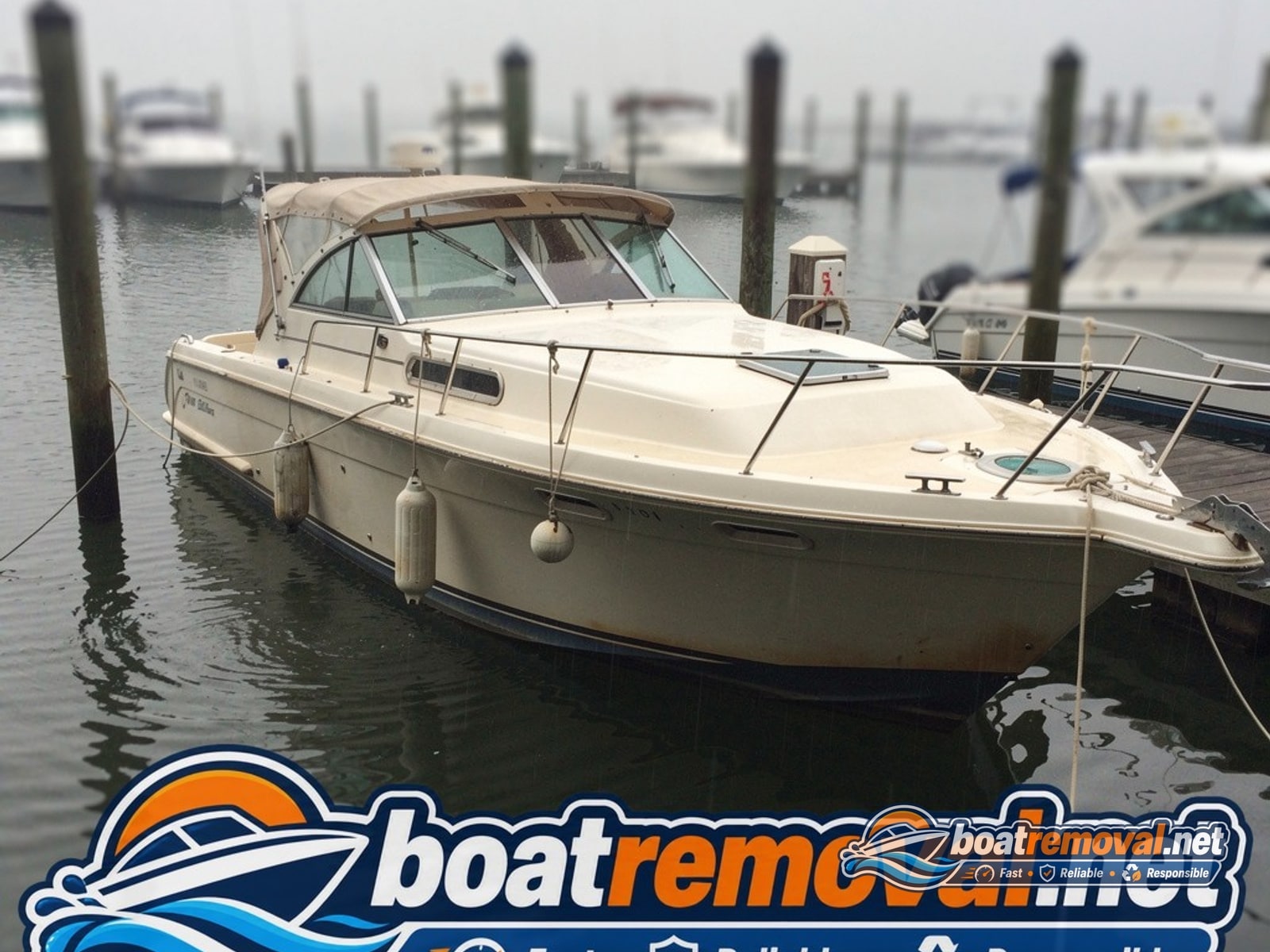 36-foot Sea Ray express cruiser sitting in a marina slip in Biloxi, Mississippi before removal