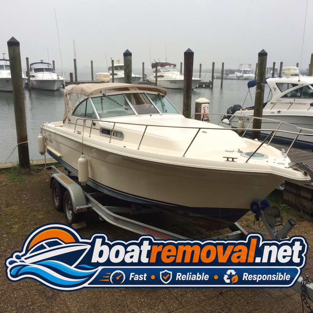 Same Sea Ray express cruiser blocked on a heavy trailer after being pulled from the slip