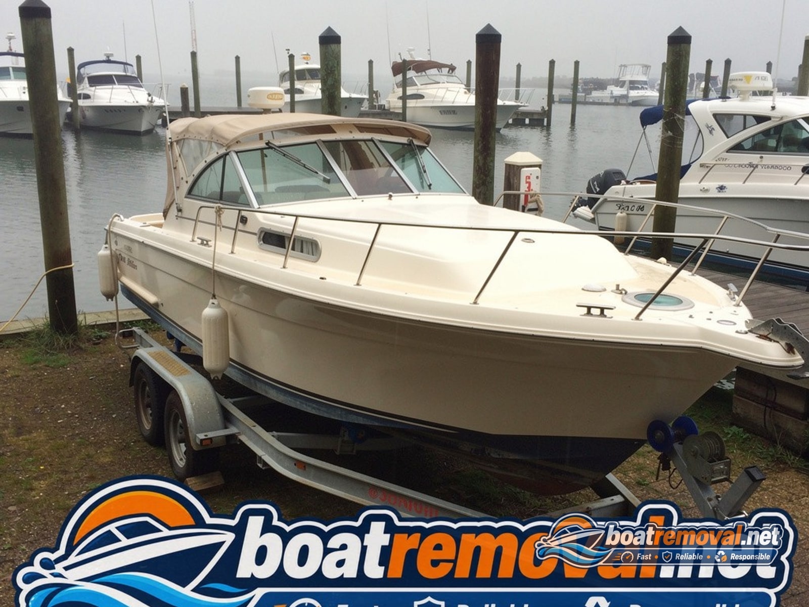Biloxi, MS: 36-foot Sea Ray express cruiser loaded for removal Same Sea Ray express cruiser blocked on a heavy trailer after being pulled from the slip