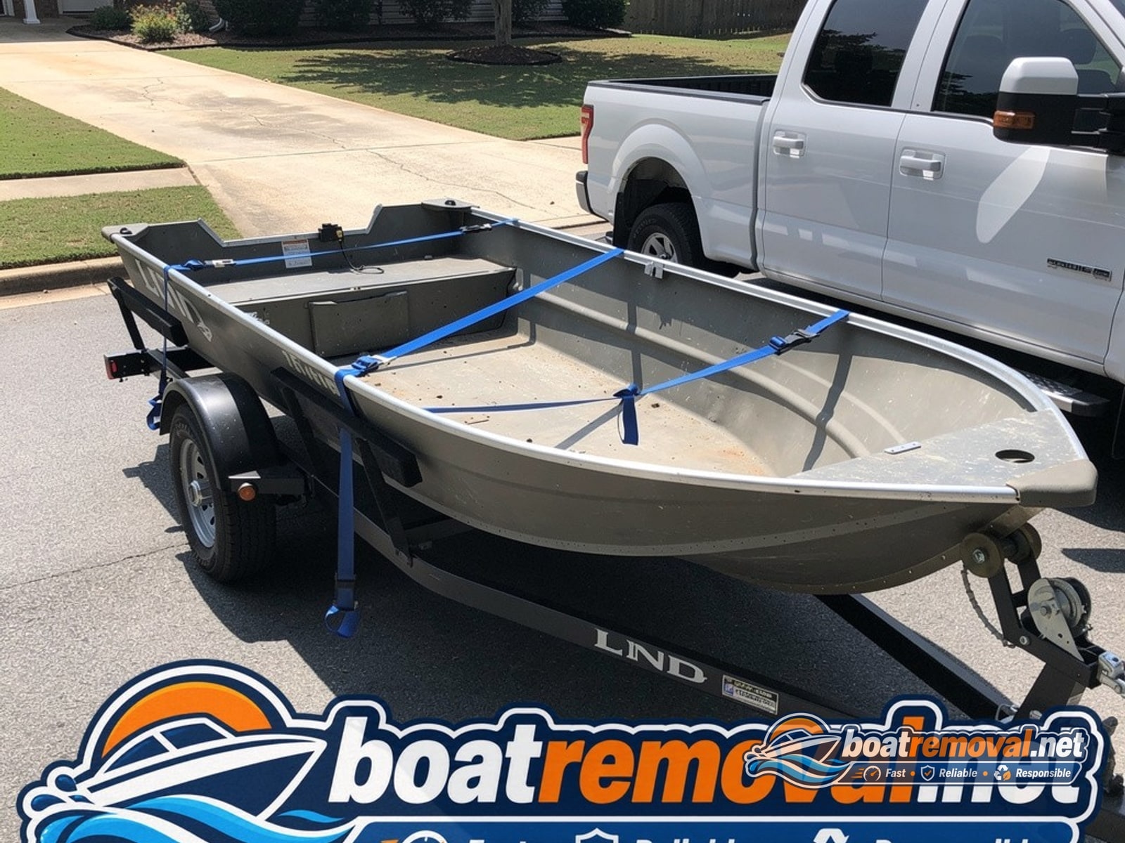 Birmingham, AL: 16-foot Lund aluminum fishing boat loaded for removal Lund aluminum fishing boat loaded onto a trailer after driveway pickup in Birmingham, Alabama