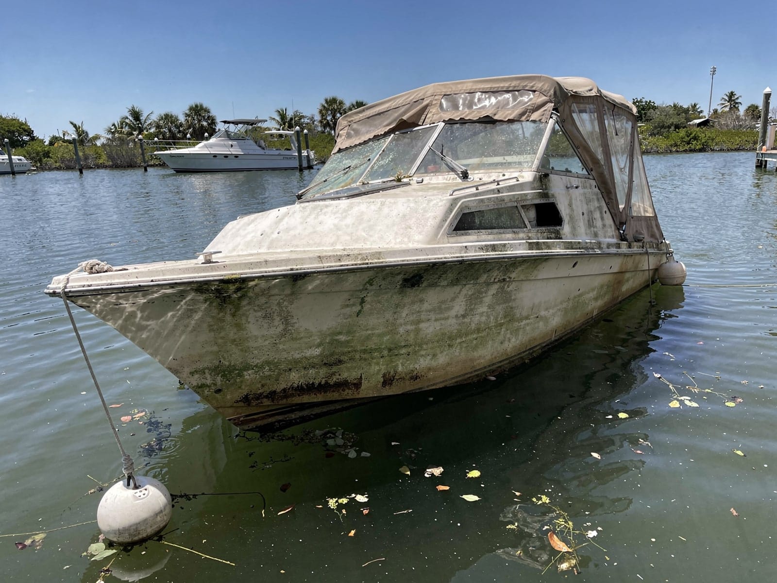 Sunken boat recovery in Cooper City, FL: before Sunken 28 ft Carver 28 at its mooring in Cooper City, FL