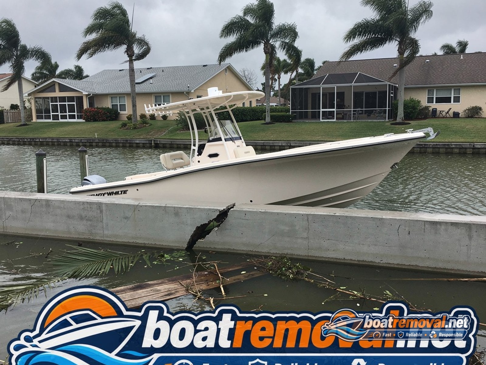 23-foot Grady-White center console driven onto a seawall after a storm in Fort Myers, Florida