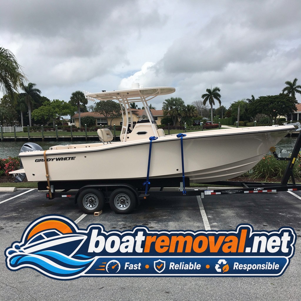Grady-White center console loaded onto a trailer after storm removal in Fort Myers, Florida