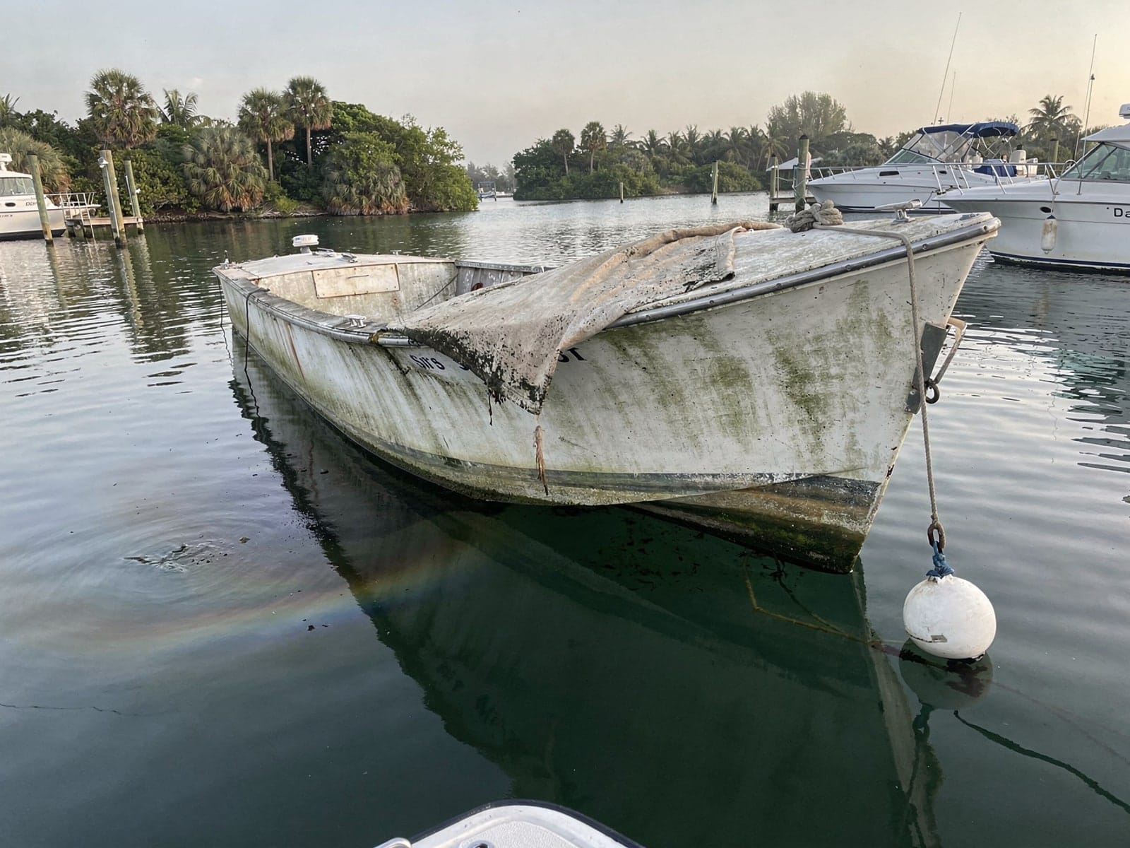 Sunken boat recovery in Pinellas Park, FL: before Sunken 27 ft Chris-Craft Commander 27 at its mooring in Pinellas Park, FL