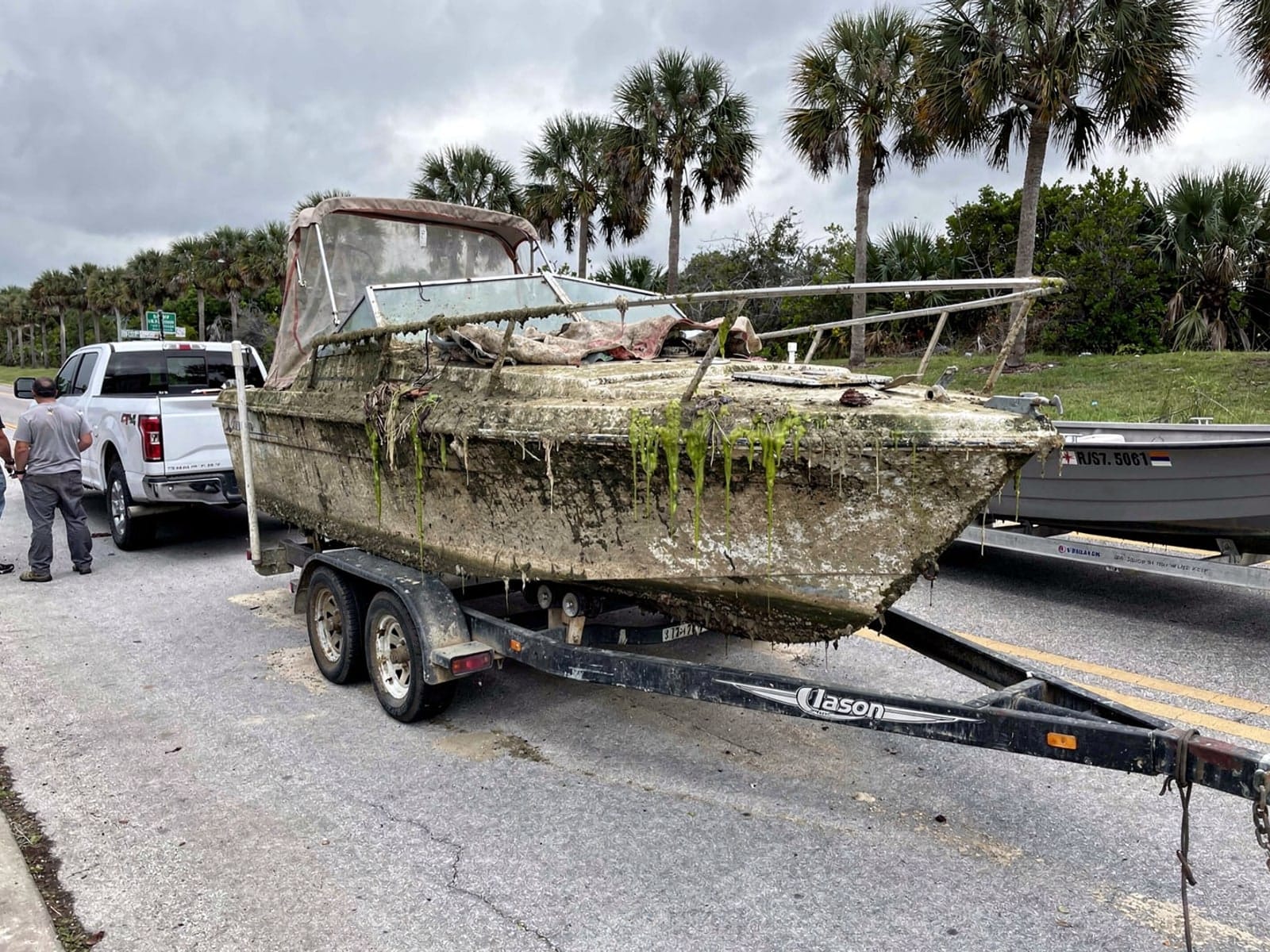 22 ft Larson 220 hauled out of West Little River, FL on a trailer after the recovery