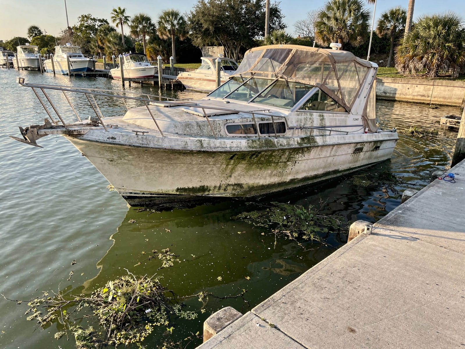 Sunken boat recovery in Brandon, FL: before Sunken 28 ft Carver 28 by a boat ramp in Brandon, FL