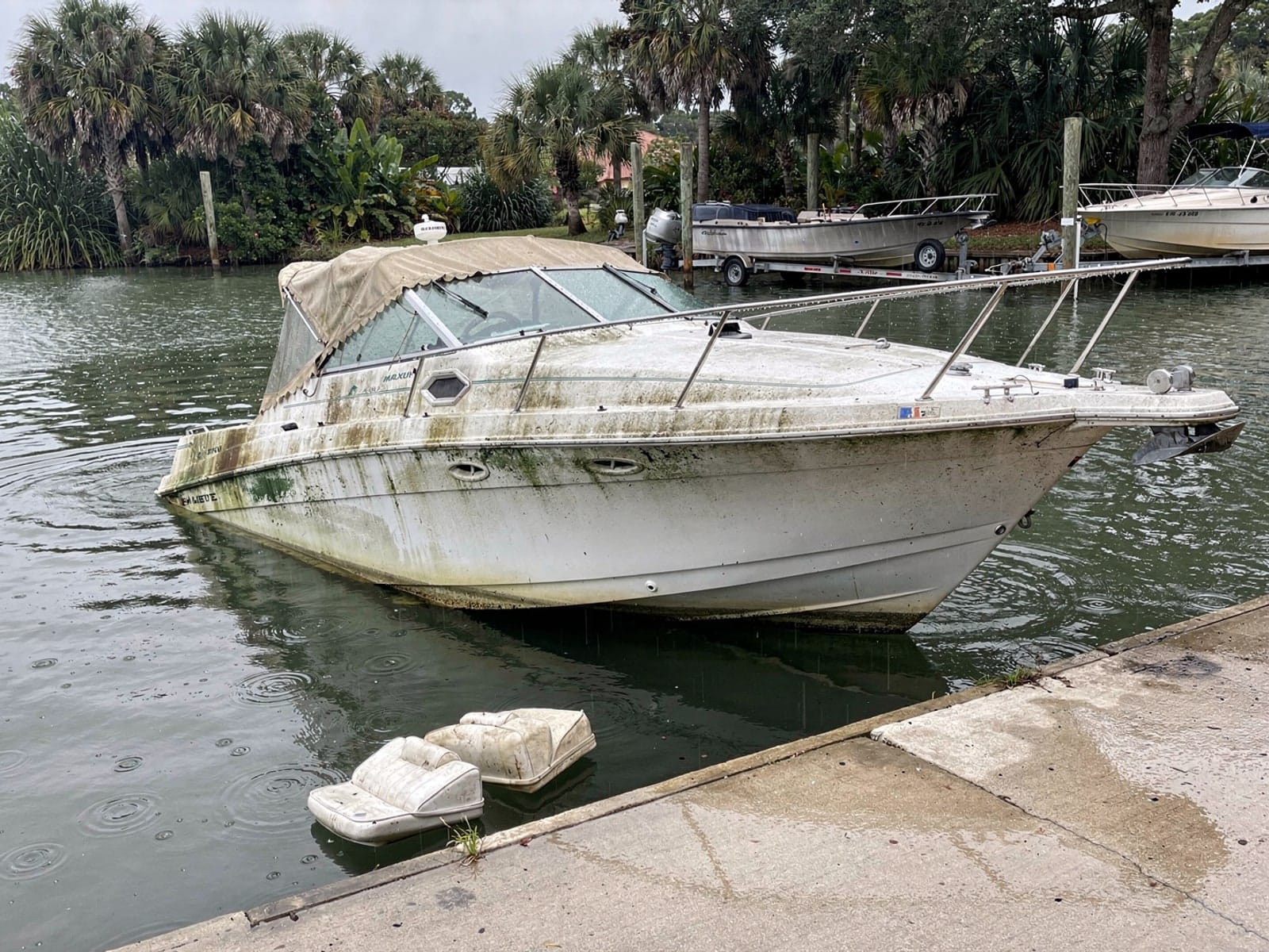 Sunken boat recovery in Cape Coral, FL: before Sunken 24 ft Maxum 2400 SCR by a boat ramp in Cape Coral, FL