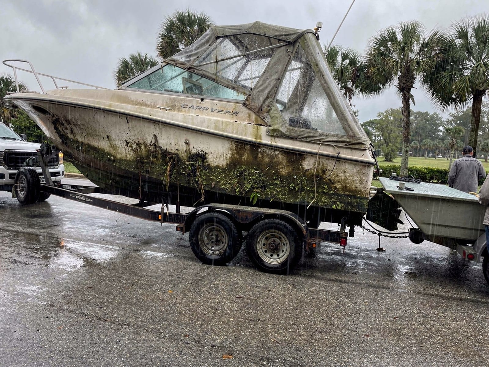 Sunken boat recovery in Four Corners, FL: hauled out on a trailer 28 ft Carver 28 hauled out of Four Corners, FL on a trailer after the recovery