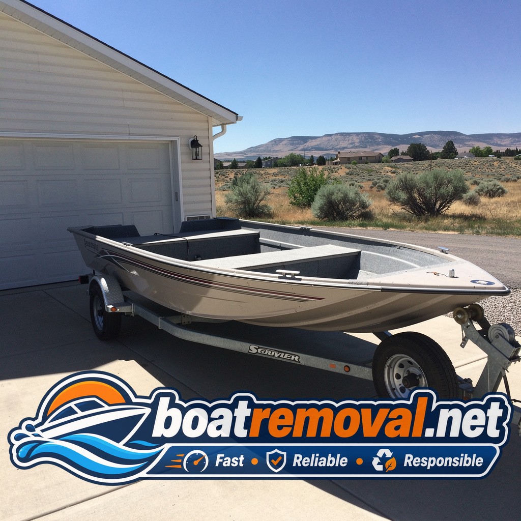Bass boat with flat trailer tires sitting behind a garage