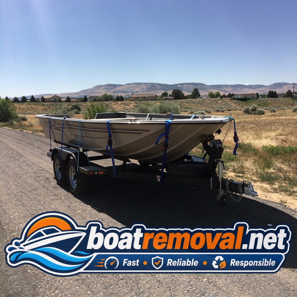 Same bass boat loaded onto a trailer after tires were freed from the driveway
