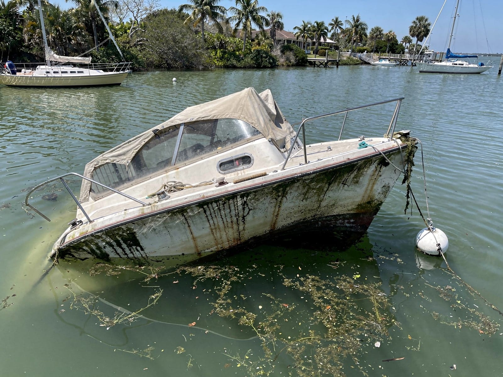 Sunken boat recovery in Casselberry, FL: before Sunken 25 ft O'Day 25 at its mooring in Casselberry, FL