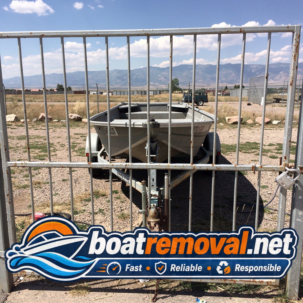 15-foot Alumacraft jon boat behind a locked gate in Colorado Springs, Colorado