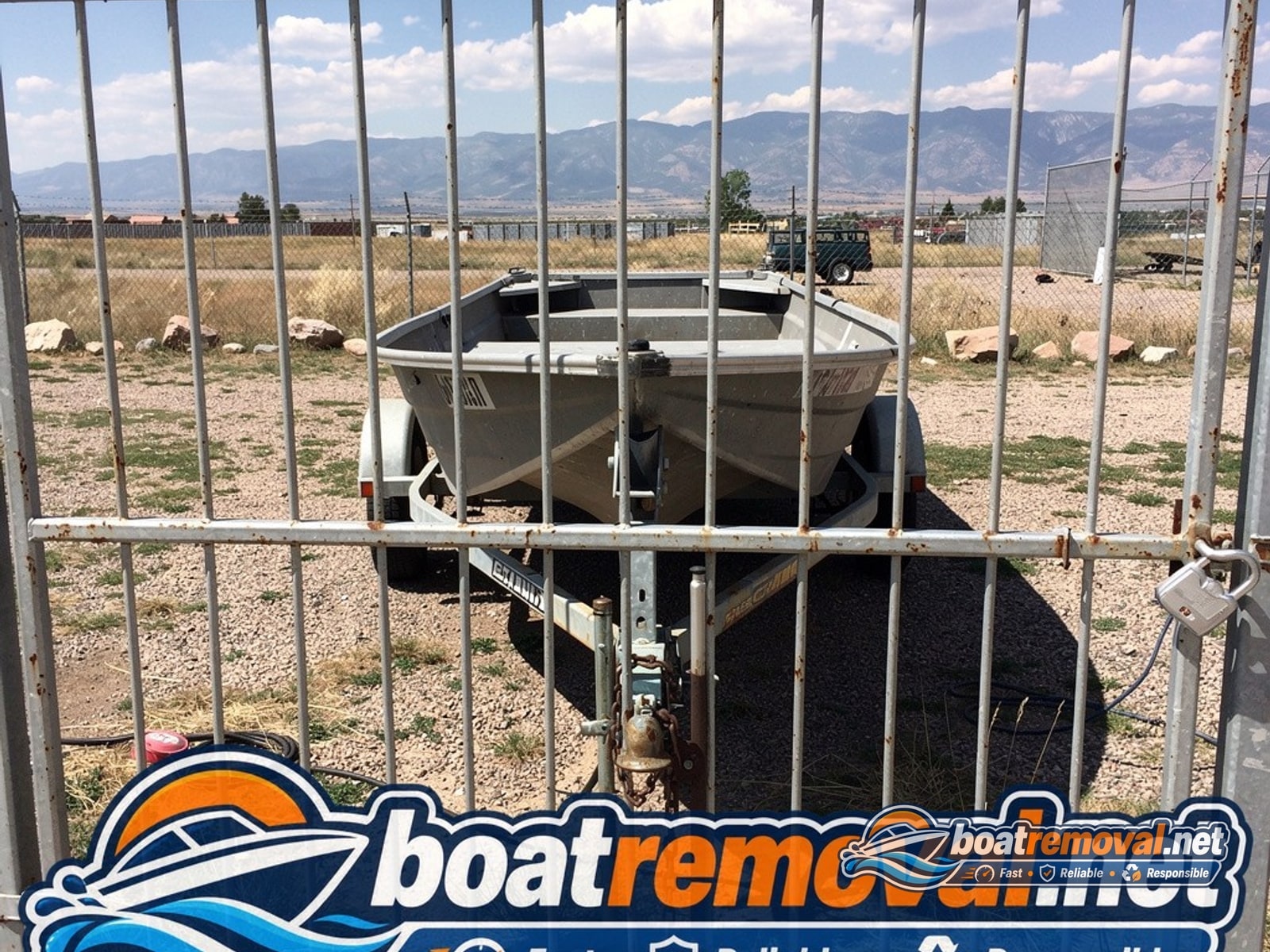 15-foot Alumacraft jon boat behind a locked gate in Colorado Springs, Colorado
