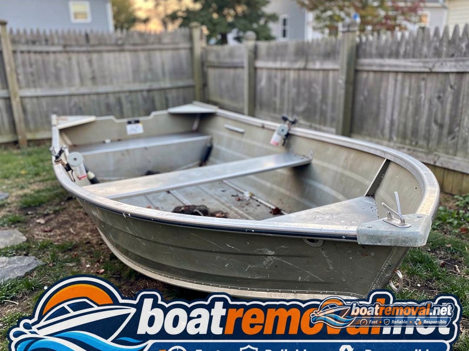 boat removal Cranston RI, 14 ft aluminum skiff in backyard
