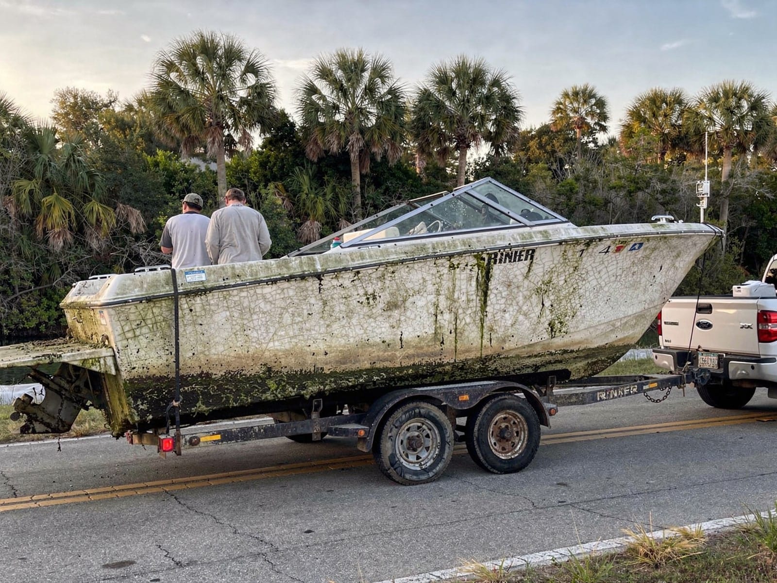 Sunken boat recovery in Dania Beach, FL: hauled out on a trailer 23 ft Rinker 232 hauled out of Dania Beach, FL on a trailer after the recovery