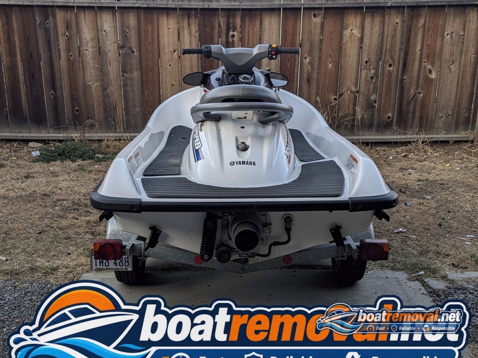 Yamaha WaveRunner jet ski on a small trailer beside a fence in Elk Grove, California