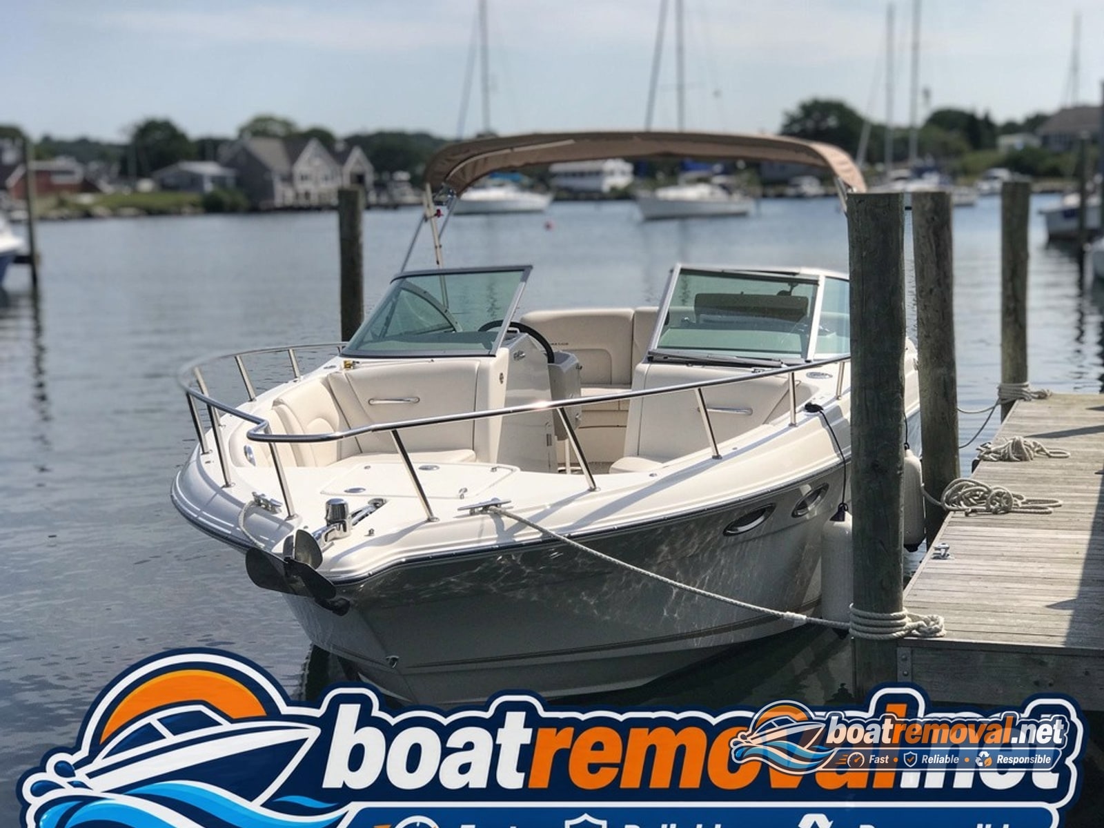 25-foot Crownline cruiser tied up in a marina slip in Falmouth, Massachusetts