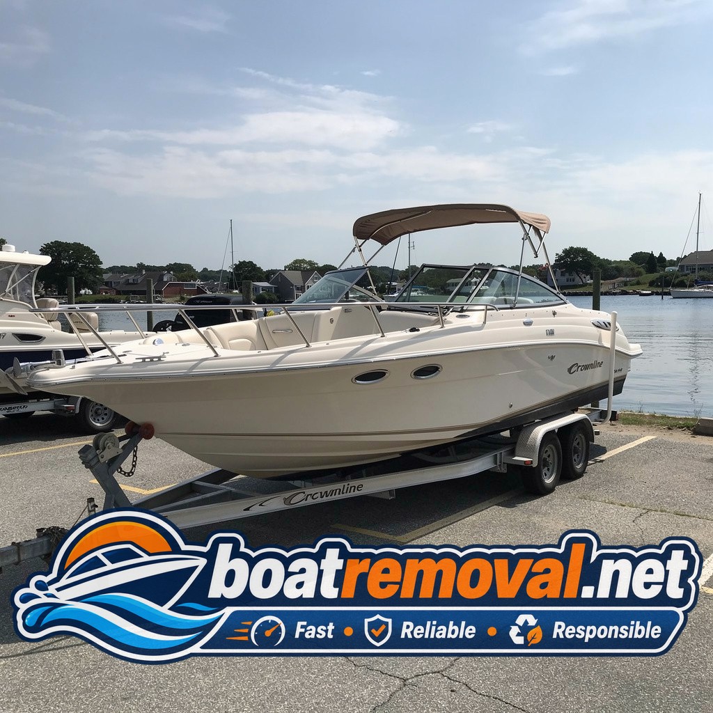 Crownline cruiser loaded onto a trailer after removal from a marina slip in Falmouth, Massachusetts