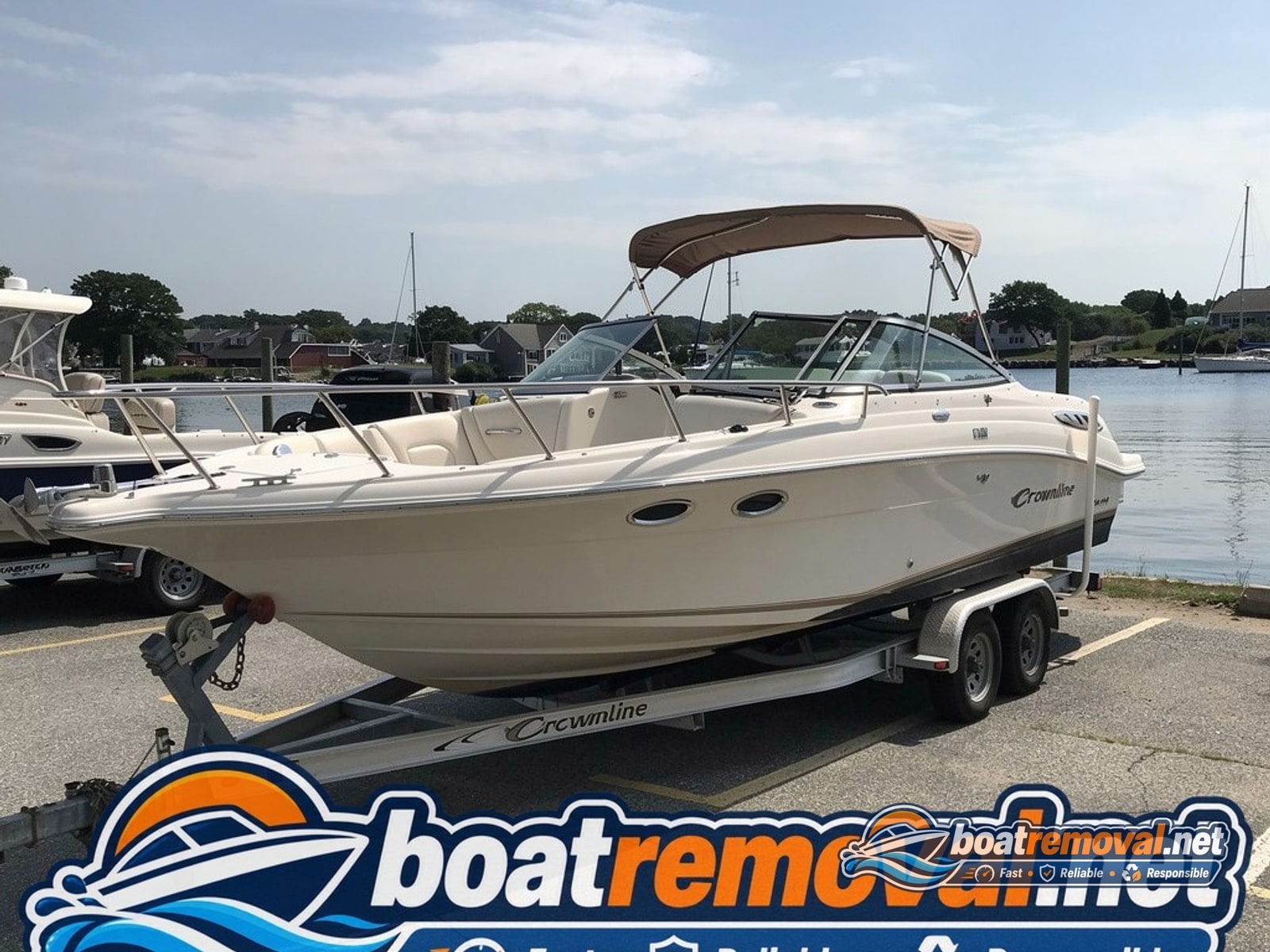Falmouth, MA: 25-foot Crownline cruiser loaded for removal Crownline cruiser loaded onto a trailer after removal from a marina slip in Falmouth, Massachusetts