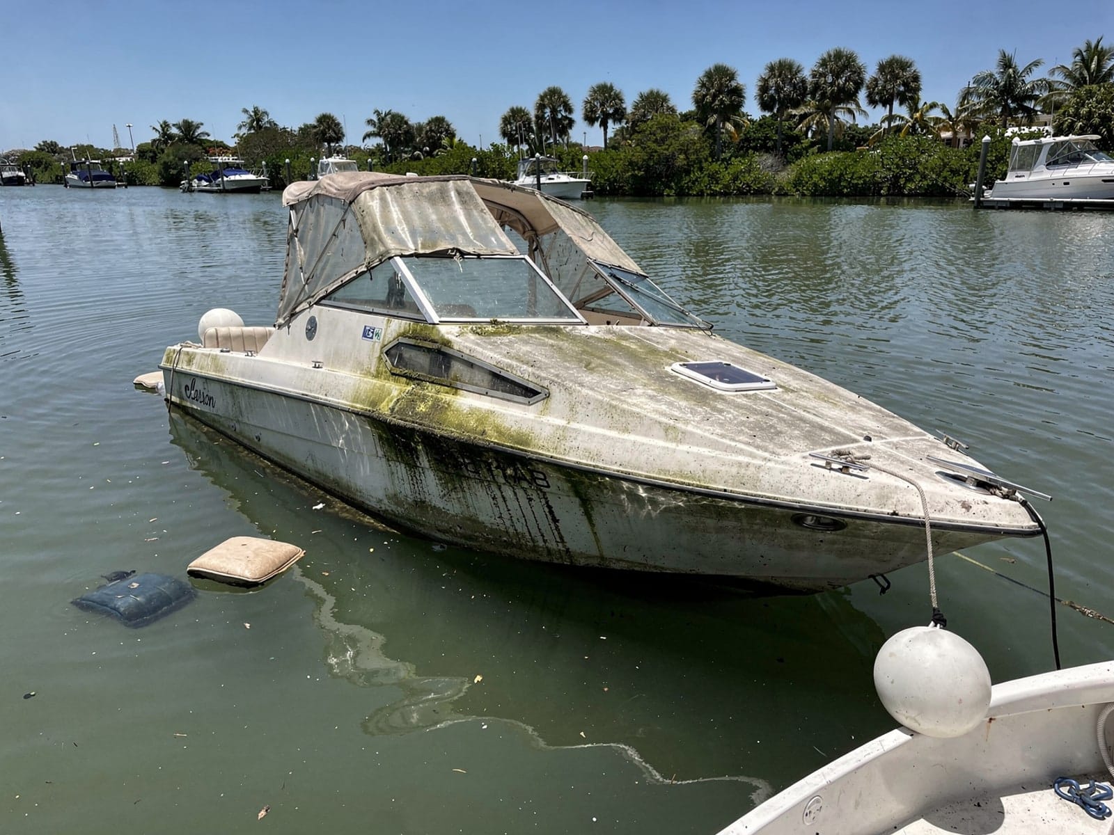 Sunken boat recovery in Fleming Island, FL: before Sunken 22 ft Larson 220 at its mooring in Fleming Island, FL