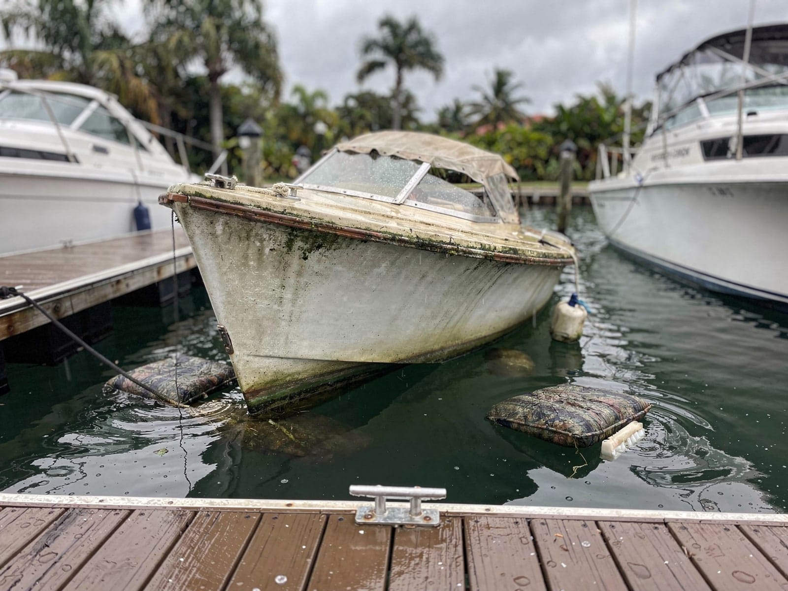 Sunken boat recovery in Fort Lauderdale, FL: before Sunken 26 ft Pearson 26 in a marina slip in Fort Lauderdale, FL