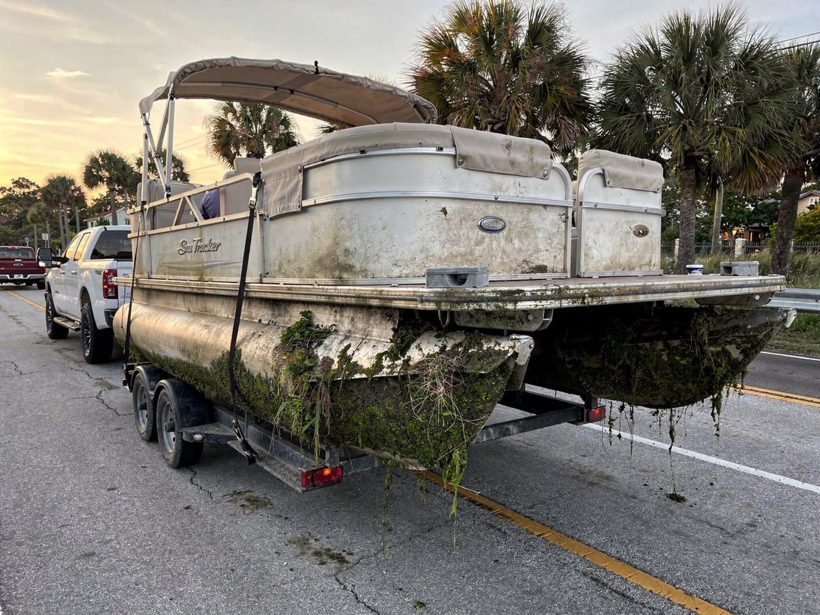 22 ft Sun Tracker Party Barge 22 hauled out of Fort Pierce, FL on a trailer after the recovery