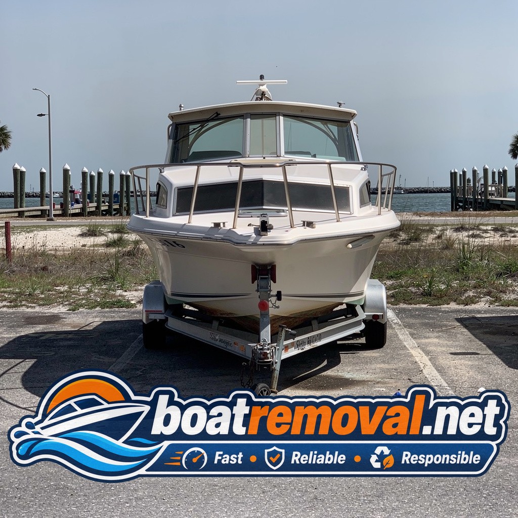 Sea Ray cabin cruiser loaded onto a trailer after removal from a Gulf Shores marina