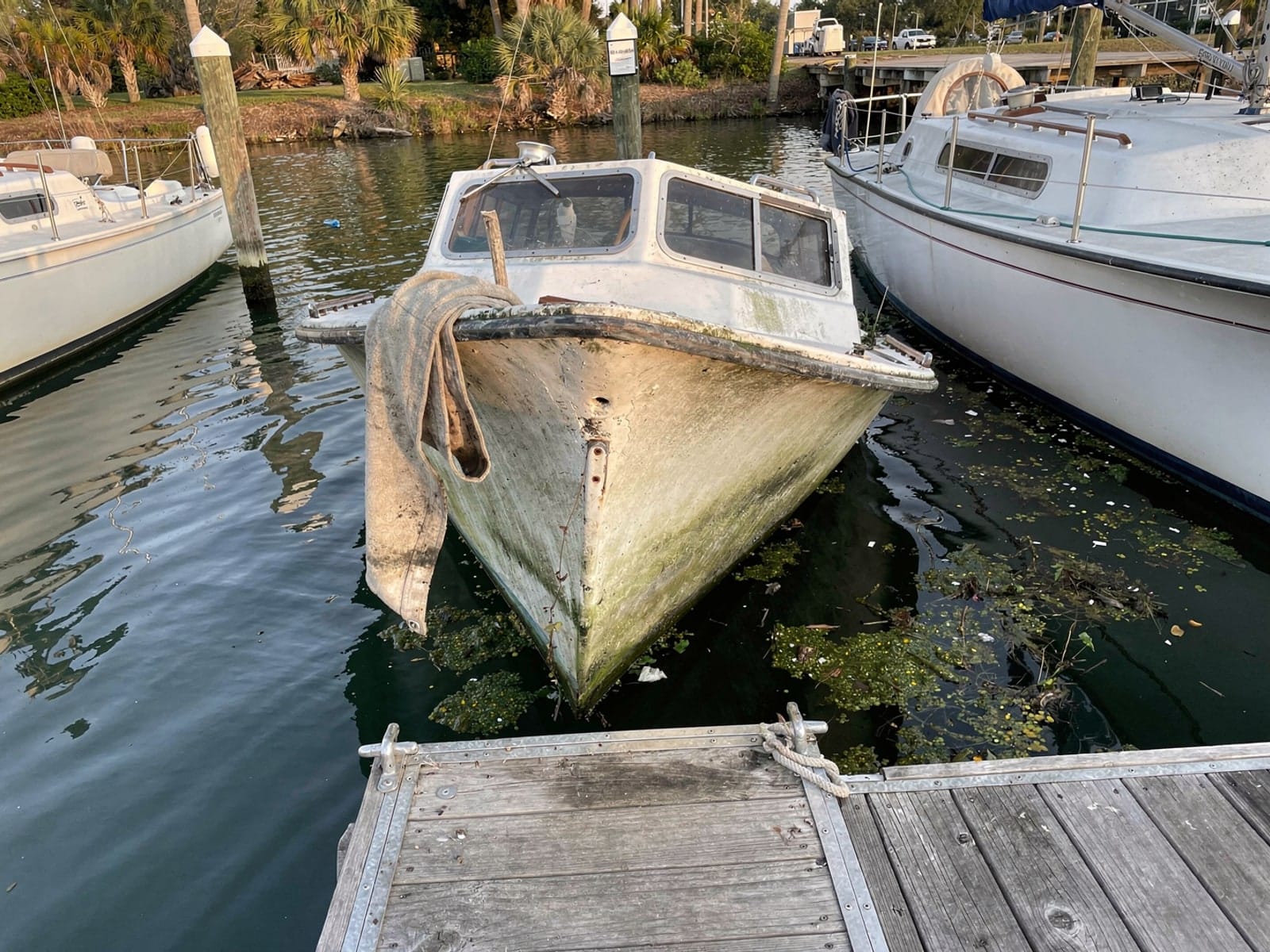 Sunken boat recovery in Bloomingdale, FL: before Sunken 26 ft Pearson 26 in a marina slip in Bloomingdale, FL
