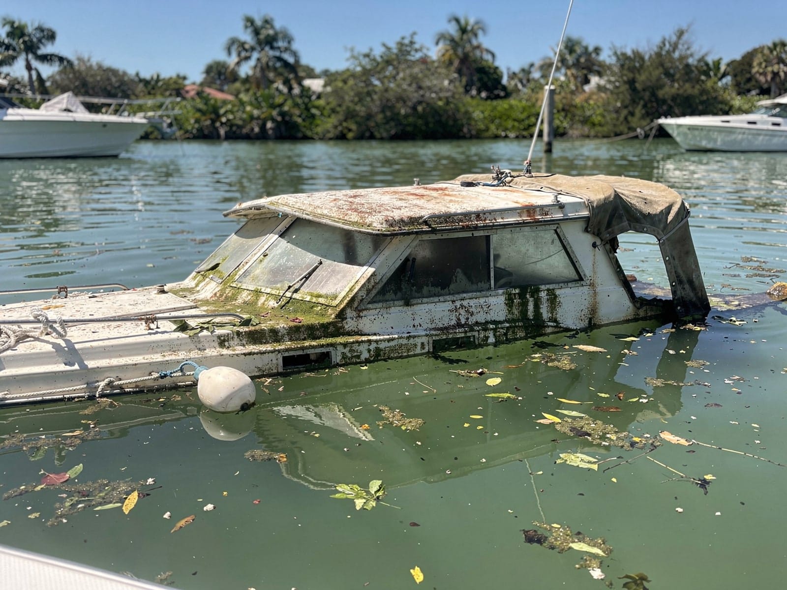 Sunken boat recovery in Lauderhill, FL: before Sunken 28 ft Carver 28 at its mooring in Lauderhill, FL
