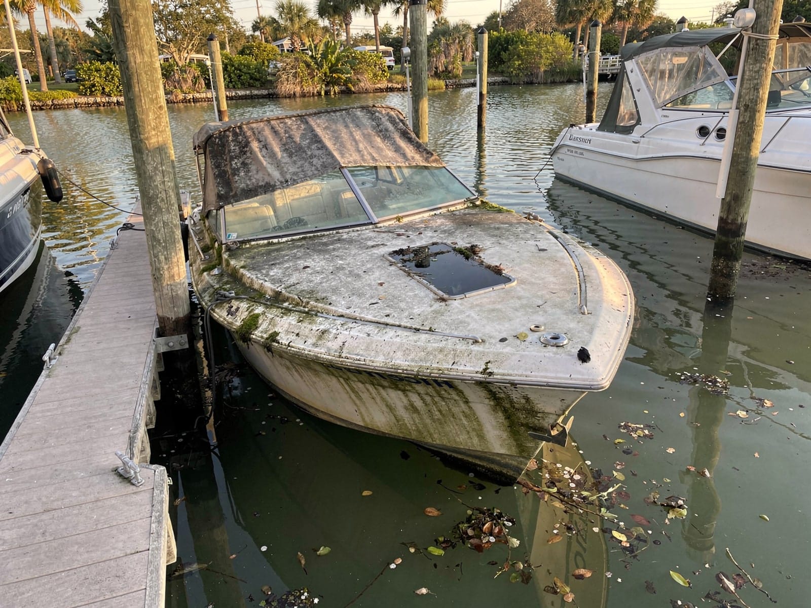 Sunken boat recovery in Lutz, FL: before Sunken 22 ft Larson 220 in a marina slip in Lutz, FL