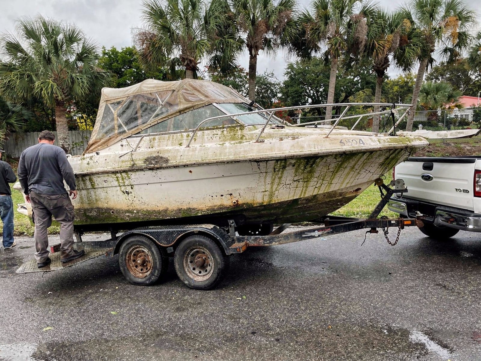 Sunken boat recovery in Navarre, FL: hauled out on a trailer 23 ft Rinker 232 hauled out of Navarre, FL on a trailer after the recovery