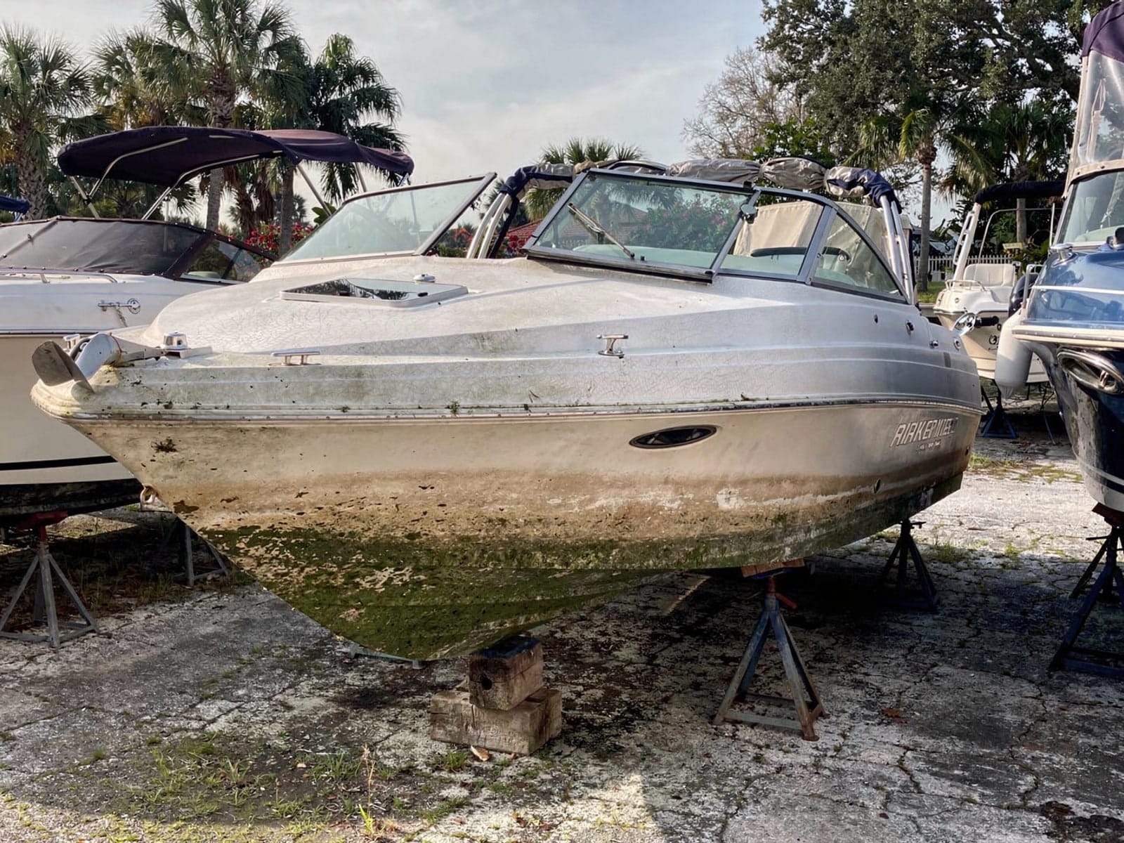 23 ft Rinker 232 from Ormond Beach, FL on stands at a repair yard after the recovery