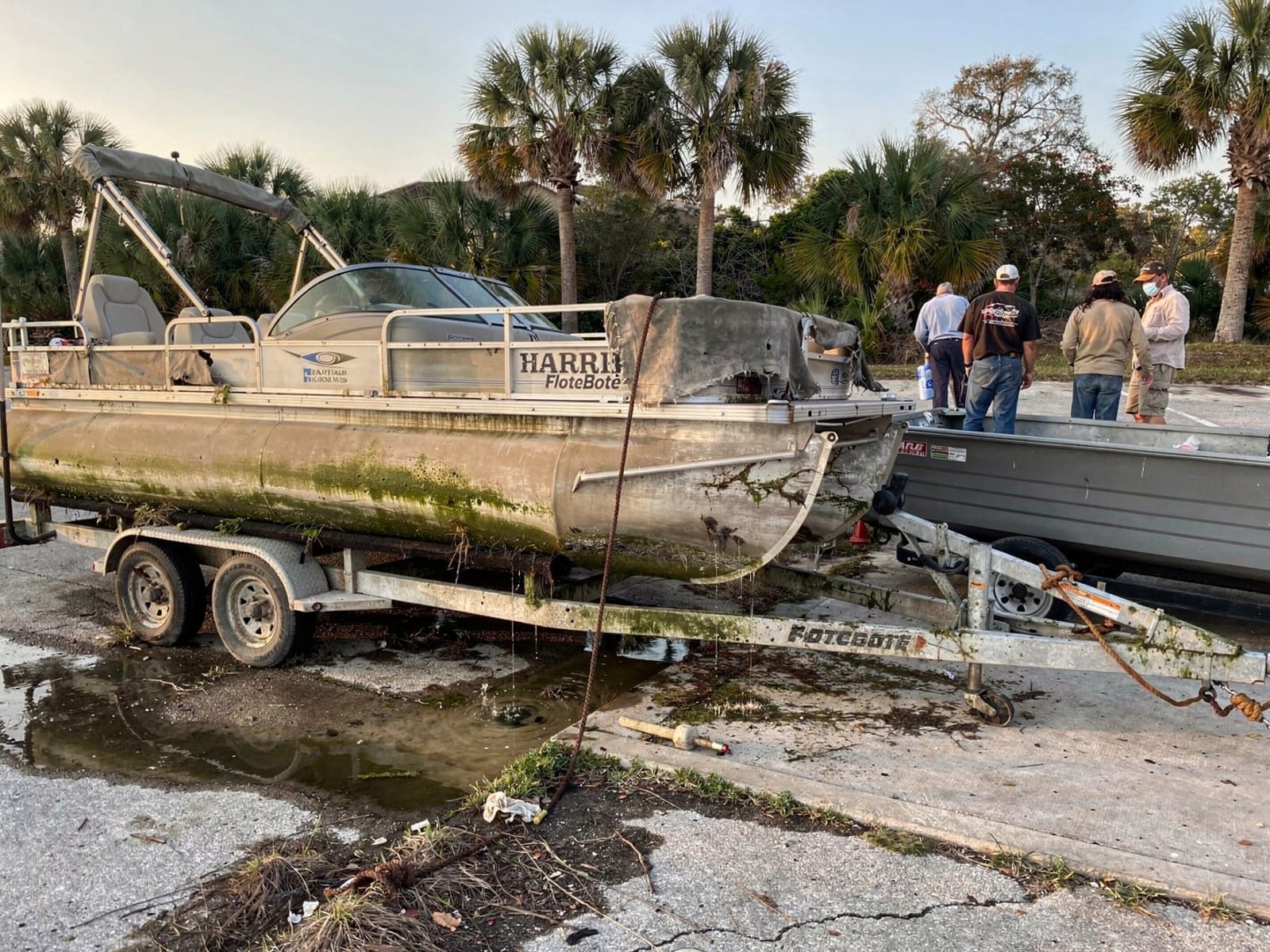 24 ft Harris FloteBote 24 pulled out on a trailer at a Holiday, FL boat ramp