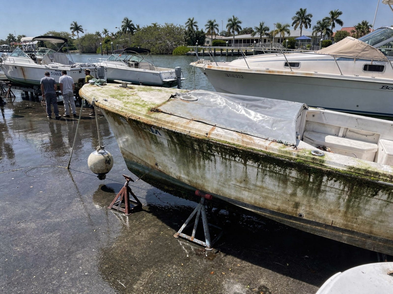 Sunken boat recovery in Immokalee, FL: at the repair yard 28 ft Bertram 28 from Immokalee, FL on stands at a repair yard after the recovery