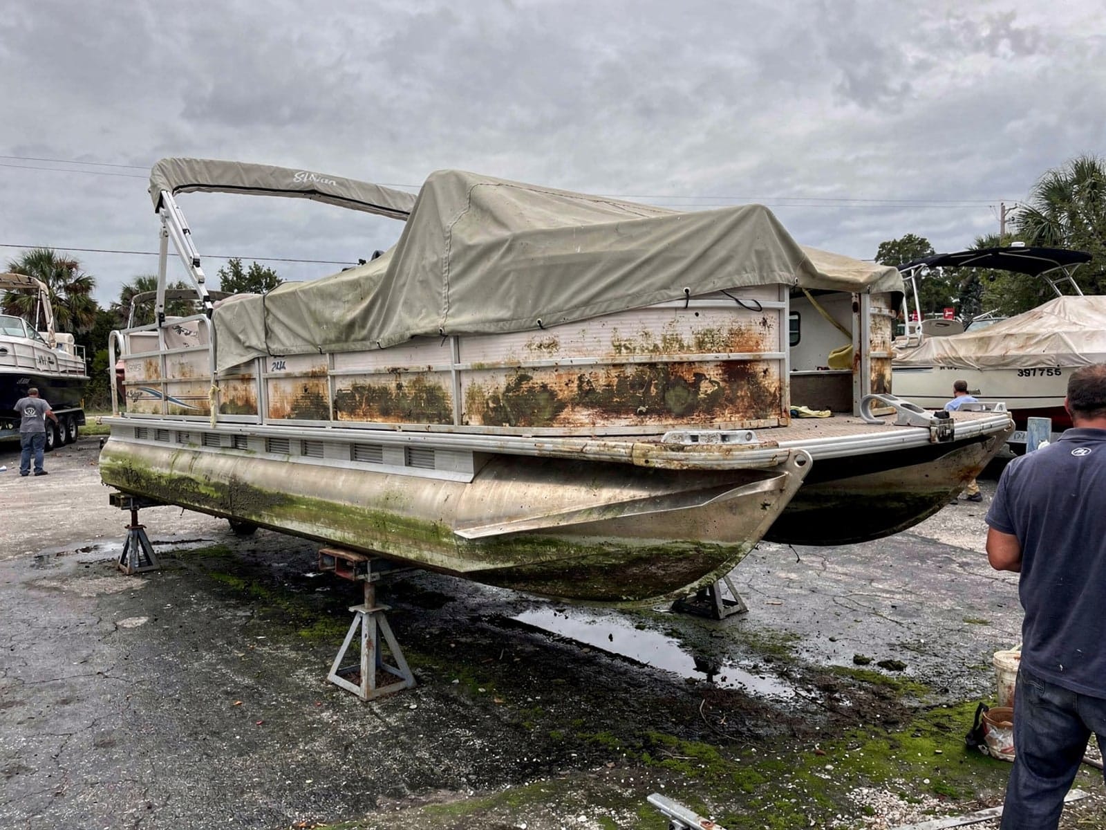 Sunken boat recovery in Lauderdale Lakes, FL: at the repair yard 20 ft Sylvan Mirage 20 from Lauderdale Lakes, FL on stands at a repair yard after the recovery