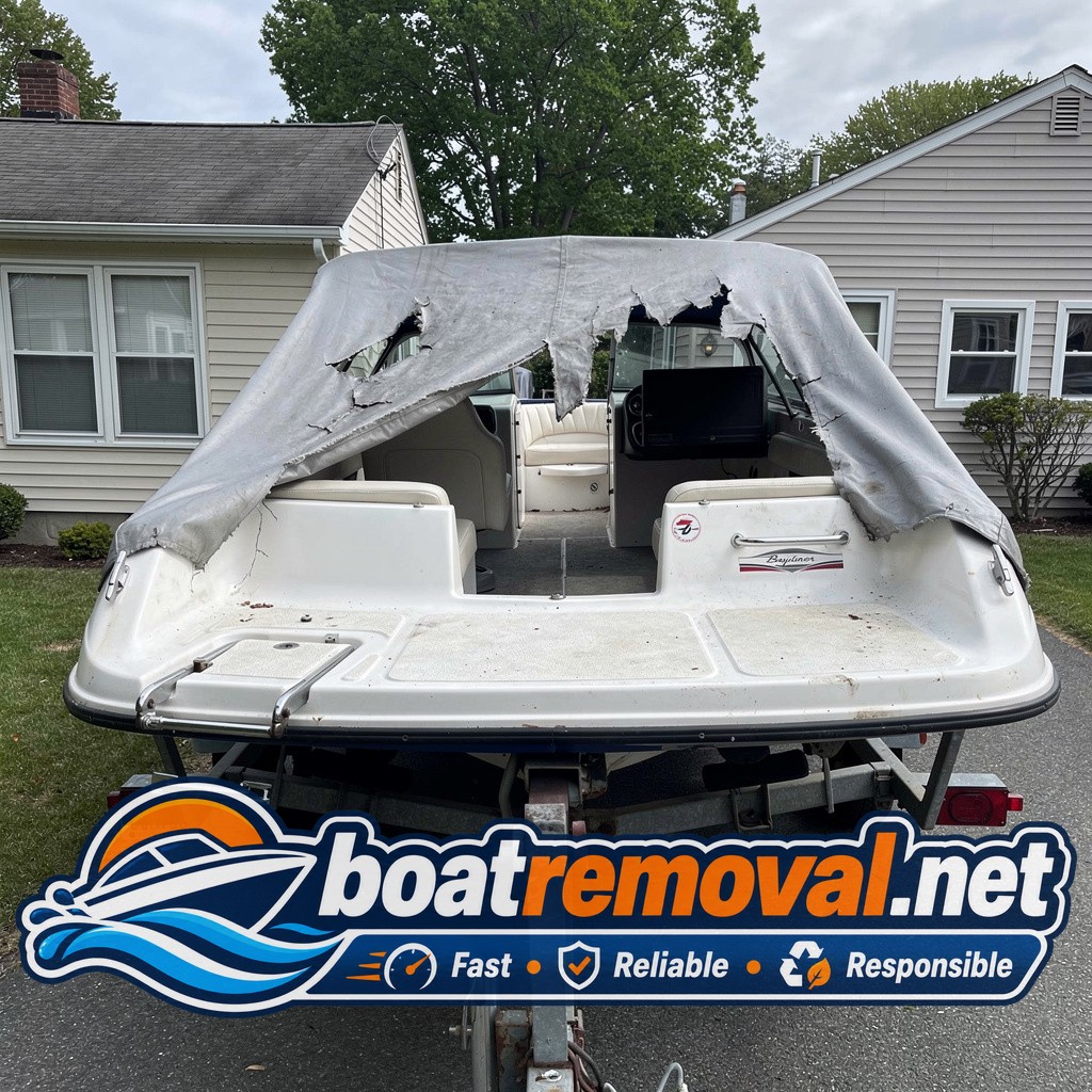boat removal Mamaroneck NY, 19 ft Bayliner bowrider under torn cover in driveway