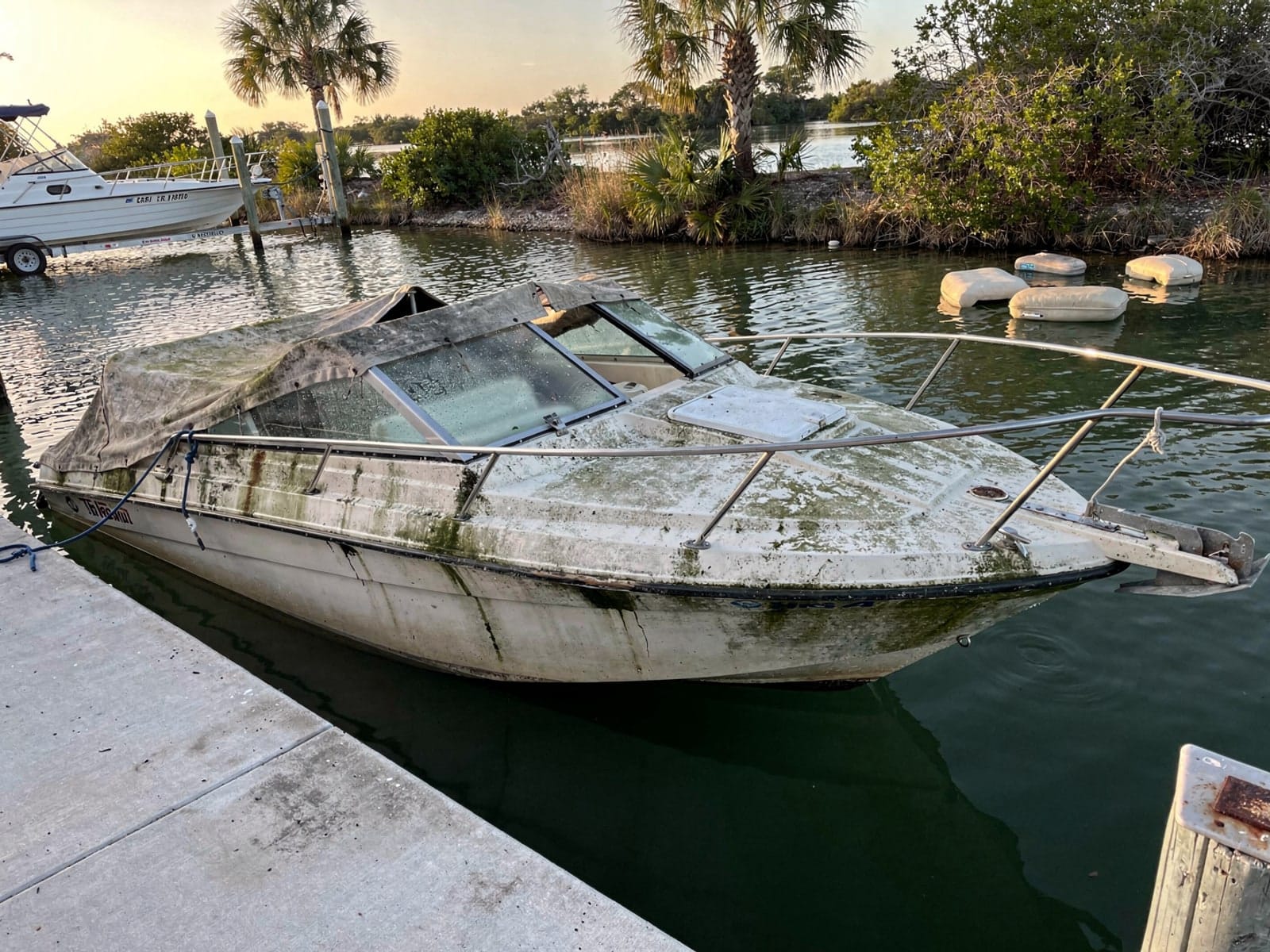 Sunken boat recovery in Fort Walton Beach, FL: before Sunken 24 ft Formula 242 by a boat ramp in Fort Walton Beach, FL