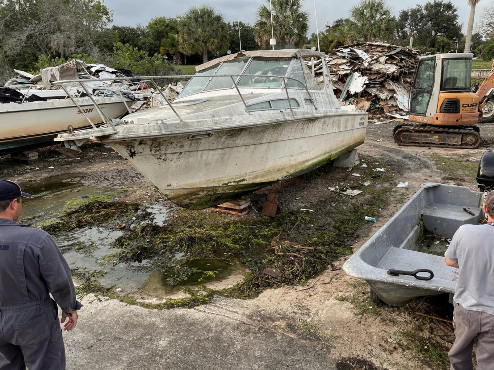 Sunken boat recovery in Gladeview, FL: at the recycling yard 28 ft Carver 28 from Gladeview, FL at the recycling yard after the recovery