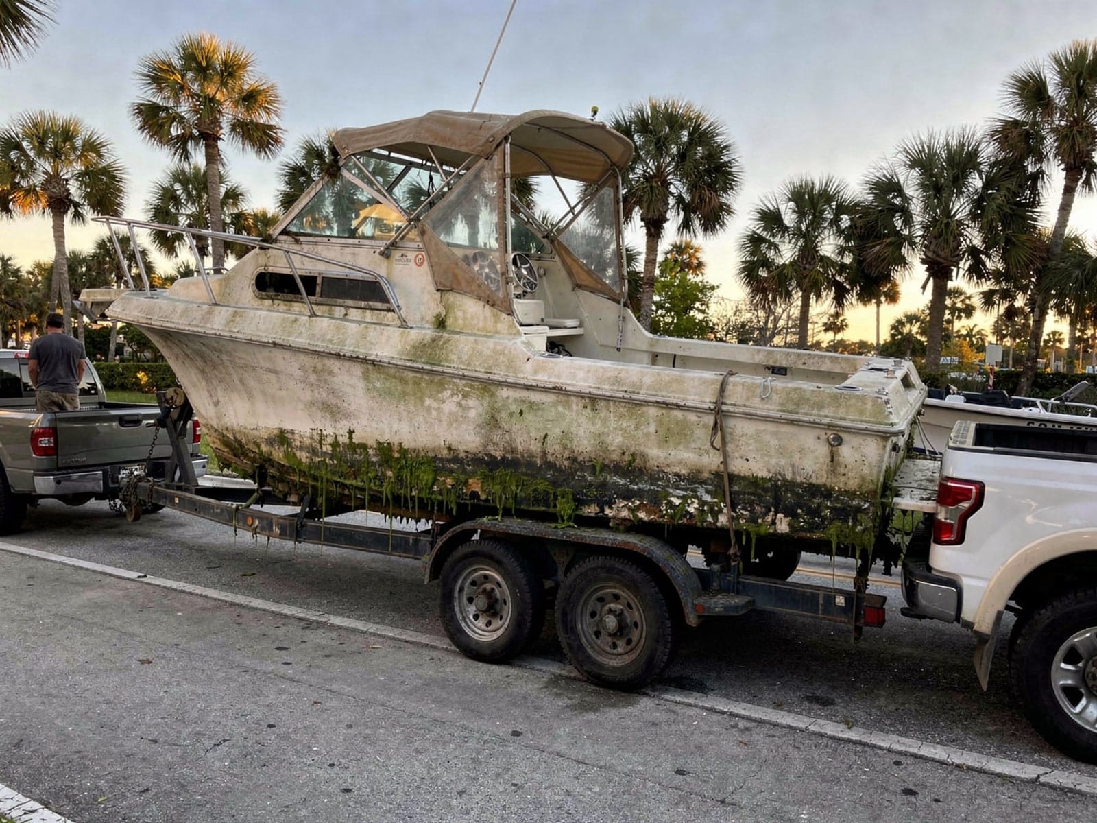 Sunken boat recovery in Merritt Island, FL: hauled out on a trailer 28 ft Bertram 28 hauled out of Merritt Island, FL on a trailer after the recovery