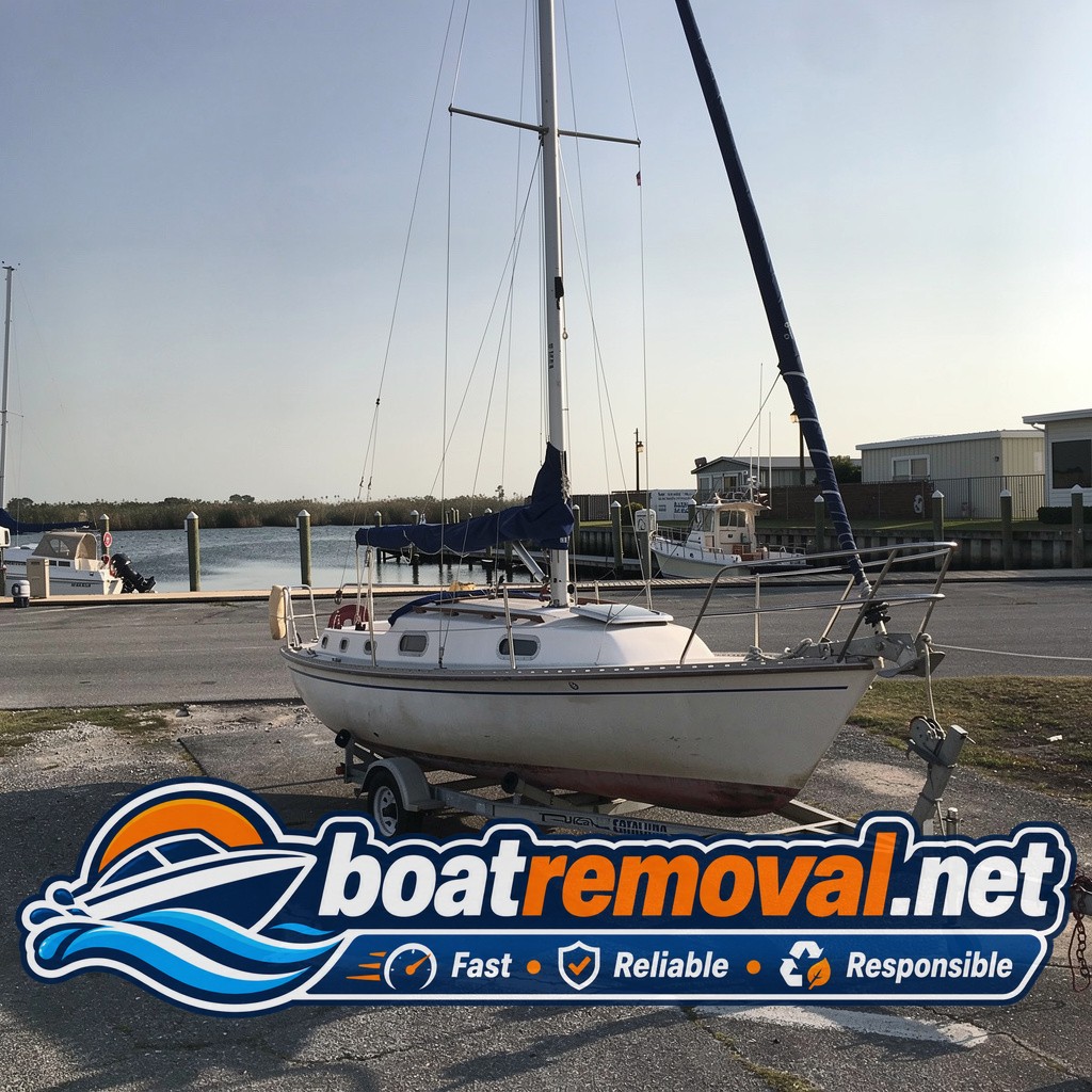 Catalina sailboat loaded onto a trailer after removal from a marina slip near Metairie, Louisiana