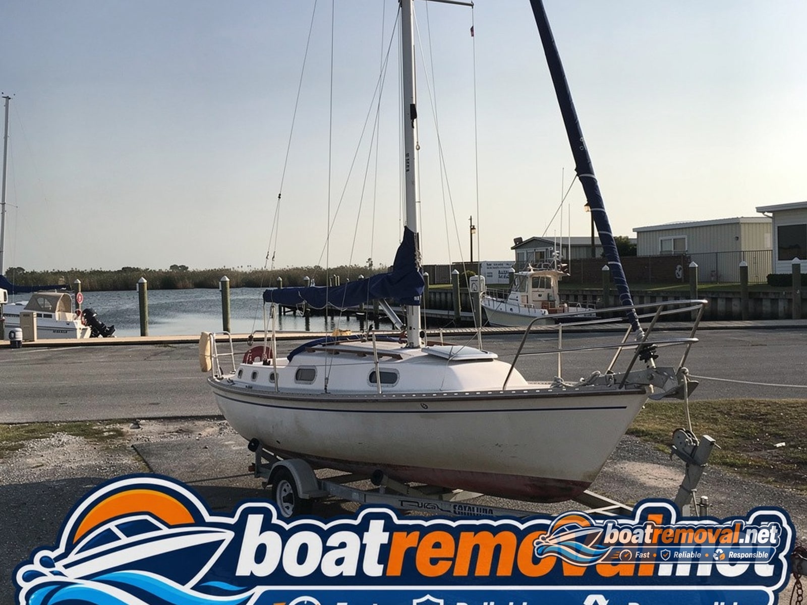 Metairie, LA: 27-foot Catalina sailboat loaded for removal Catalina sailboat loaded onto a trailer after removal from a marina slip near Metairie, Louisiana