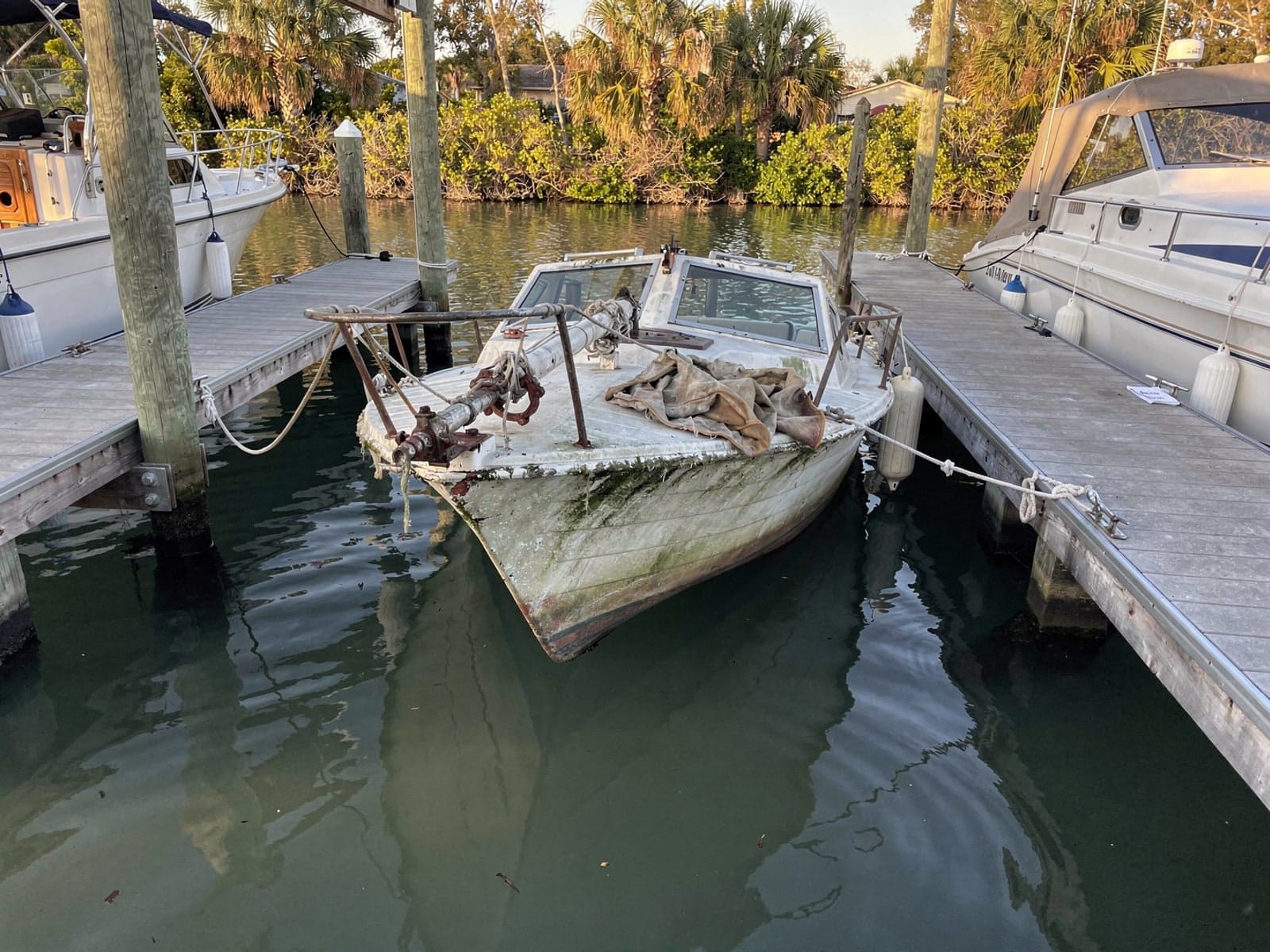 Sunken boat recovery in Miami, FL: before Sunken 22 ft Catalina 22 in a marina slip in Miami, FL