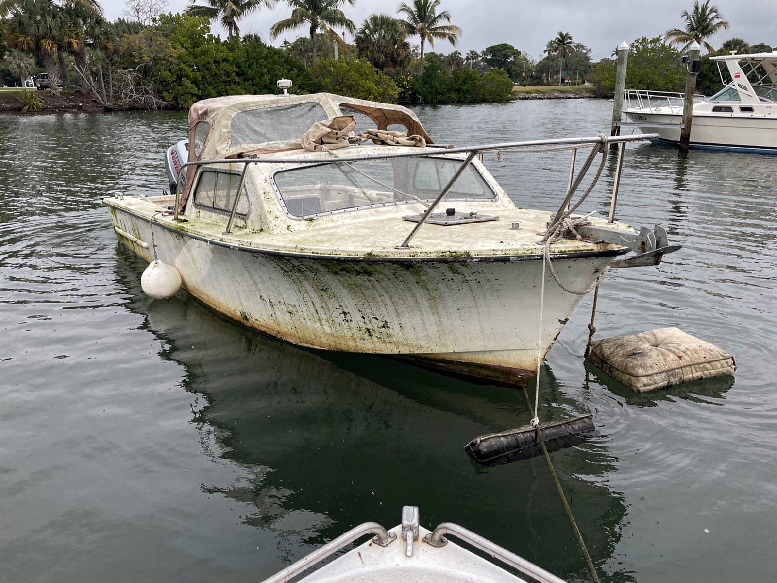 Sunken boat recovery in Miami Lakes, FL: before Sunken 21 ft Thompson 21 at its mooring in Miami Lakes, FL