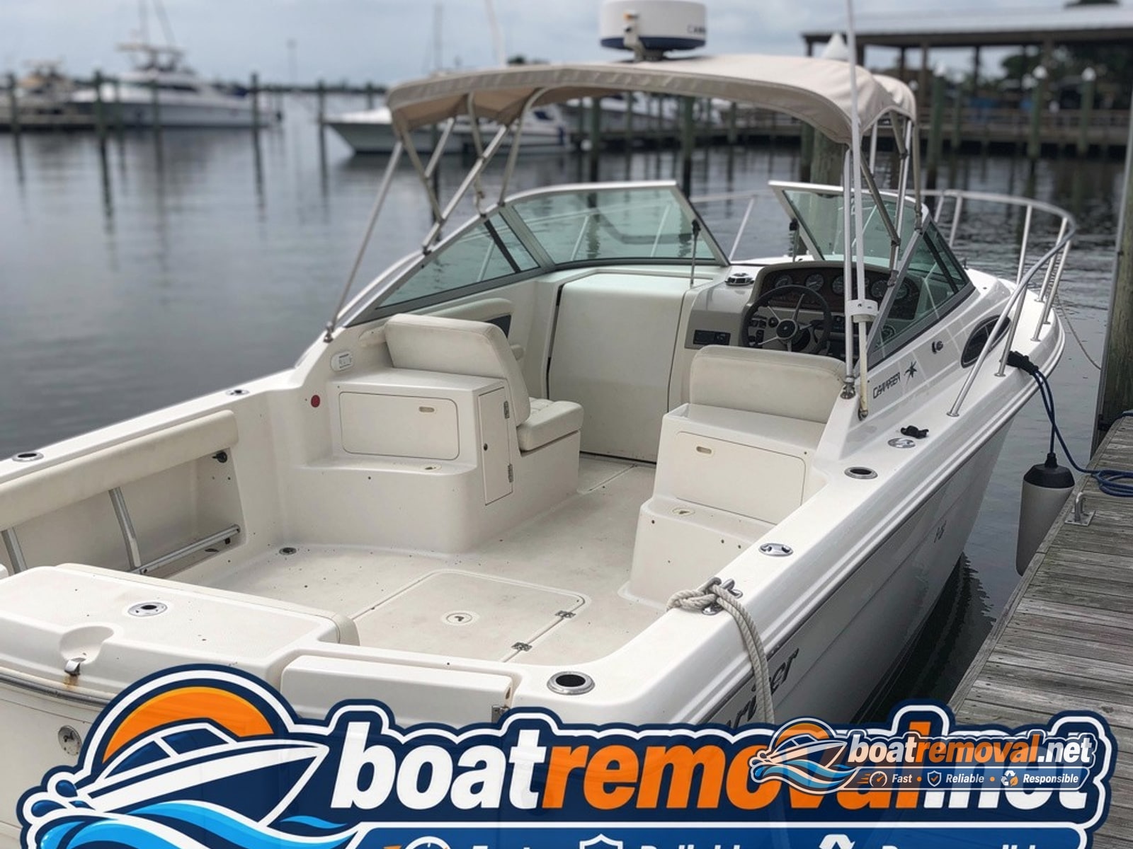 marina boat removal Morehead City NC, 26 ft Carver cabin cruiser at dock