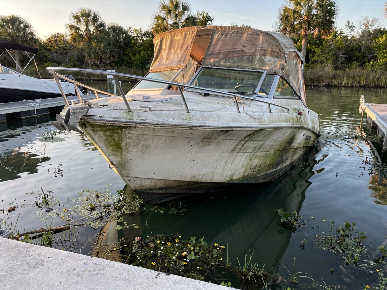 Sunken boat recovery in New Port Richey, FL: before Sunken 24 ft Formula 242 by a boat ramp in New Port Richey, FL
