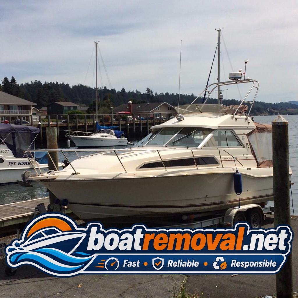 30 ft Bayliner cabin cruiser loaded for removal, Newport Oregon